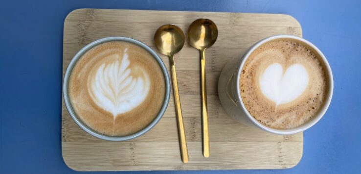 two cups of coffee with a heart design on top