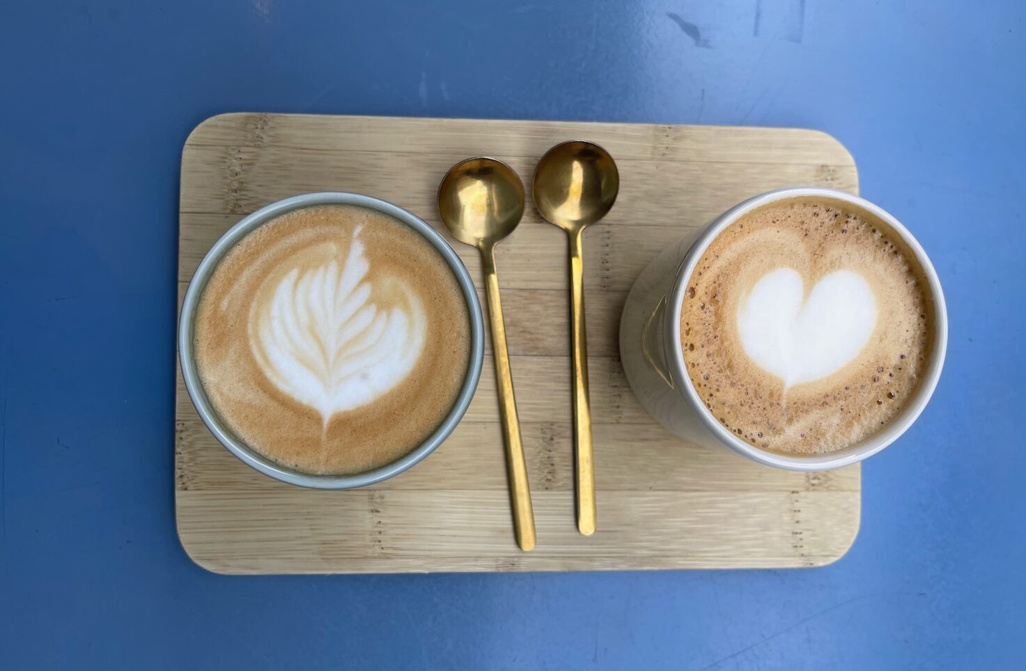 two cups of coffee with a heart design on top