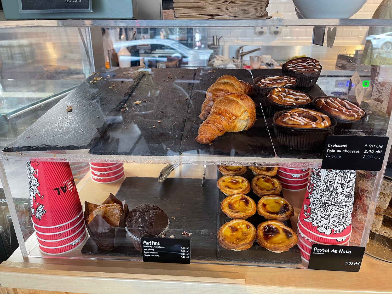 a display case with pastries and cupcakes