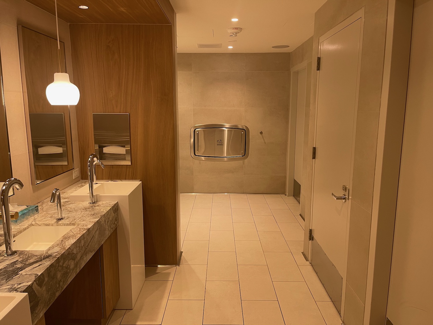 a bathroom with a sink and mirrors