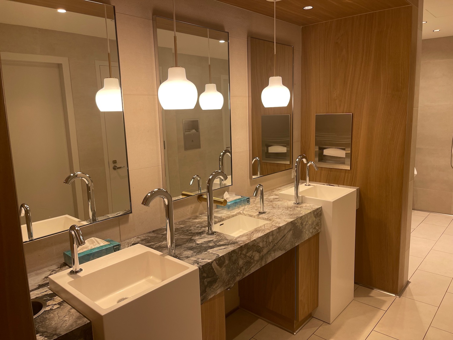 a bathroom with sinks and mirrors