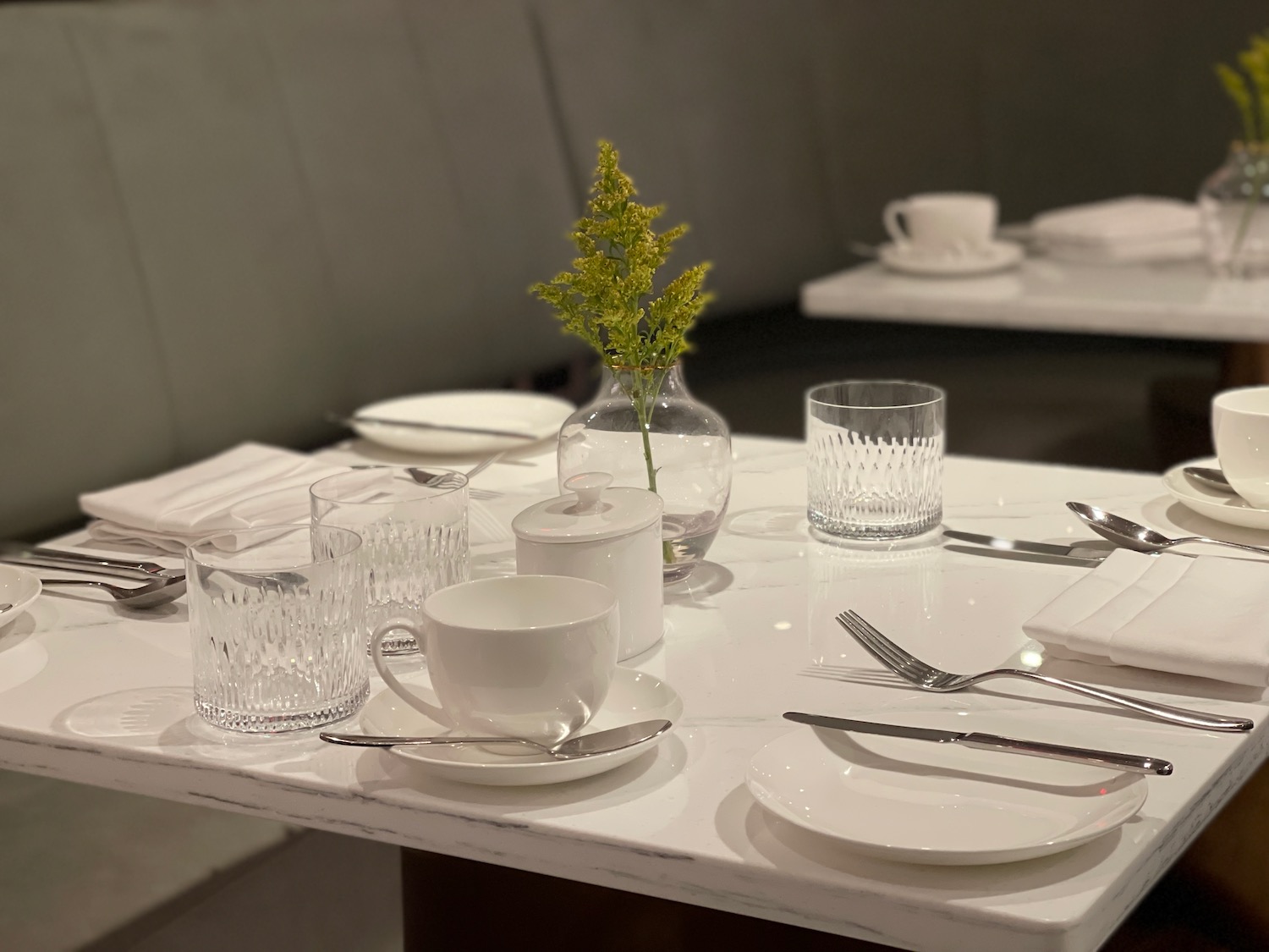 a table with white plates and silverware