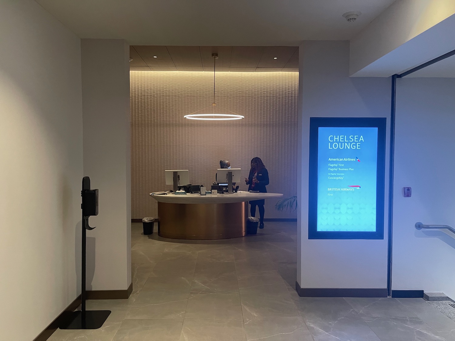 a woman standing in front of a reception desk