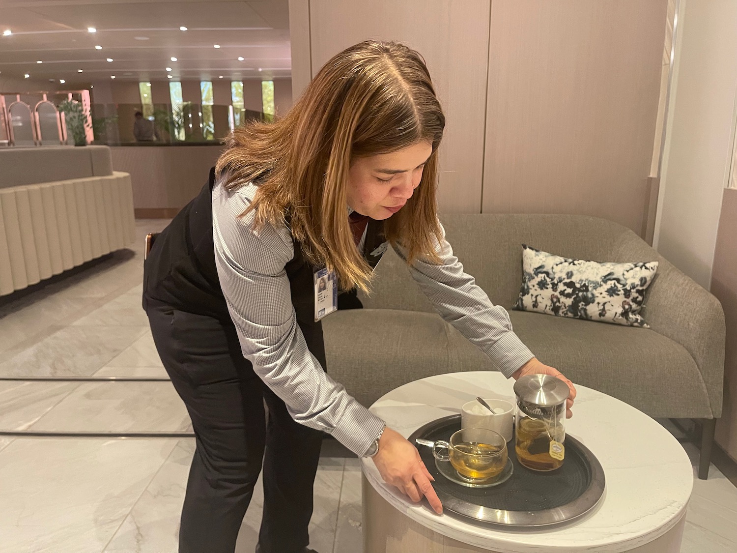 a woman serving tea on a tray