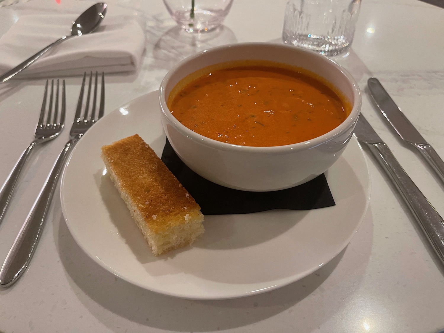 a bowl of soup and bread on a plate