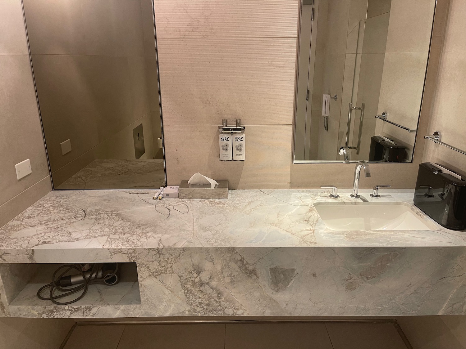 a bathroom with a marble countertop and a mirror