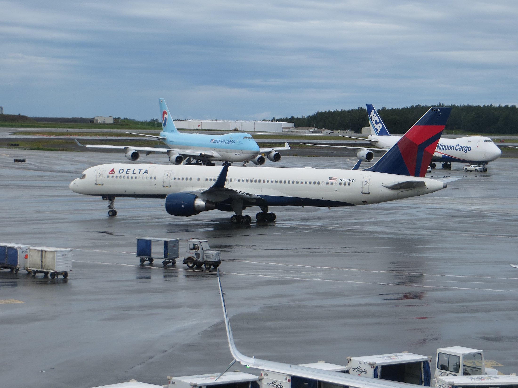 a group of airplanes on a wet runway