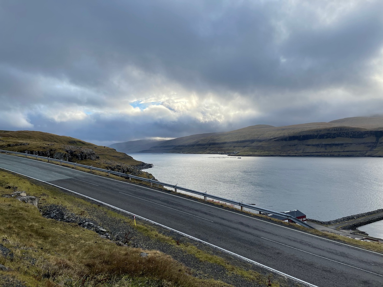 a road next to a body of water