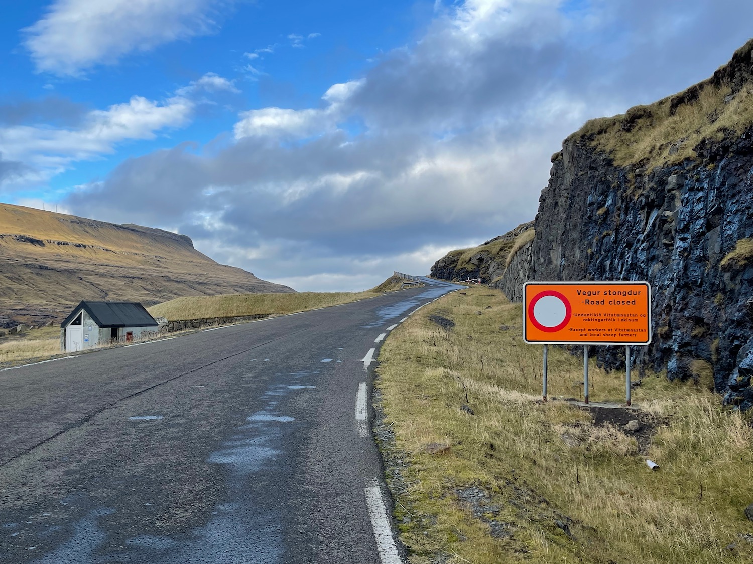 a road with a sign on the side