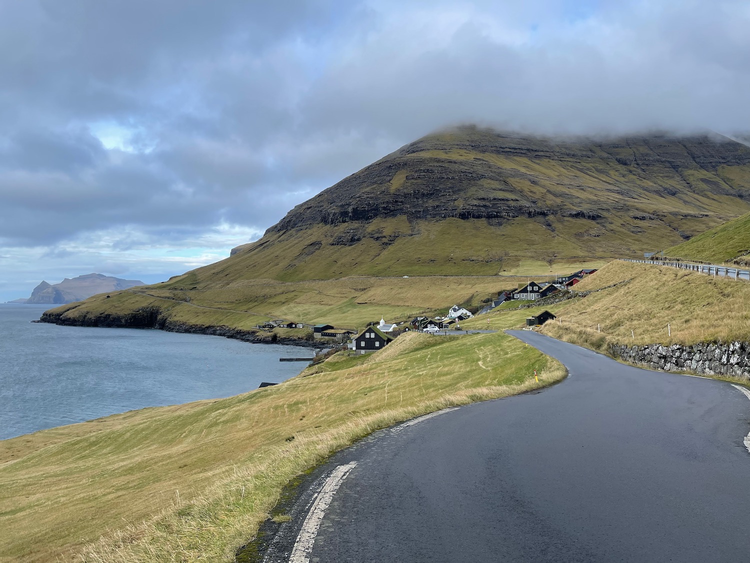 a road next to a body of water