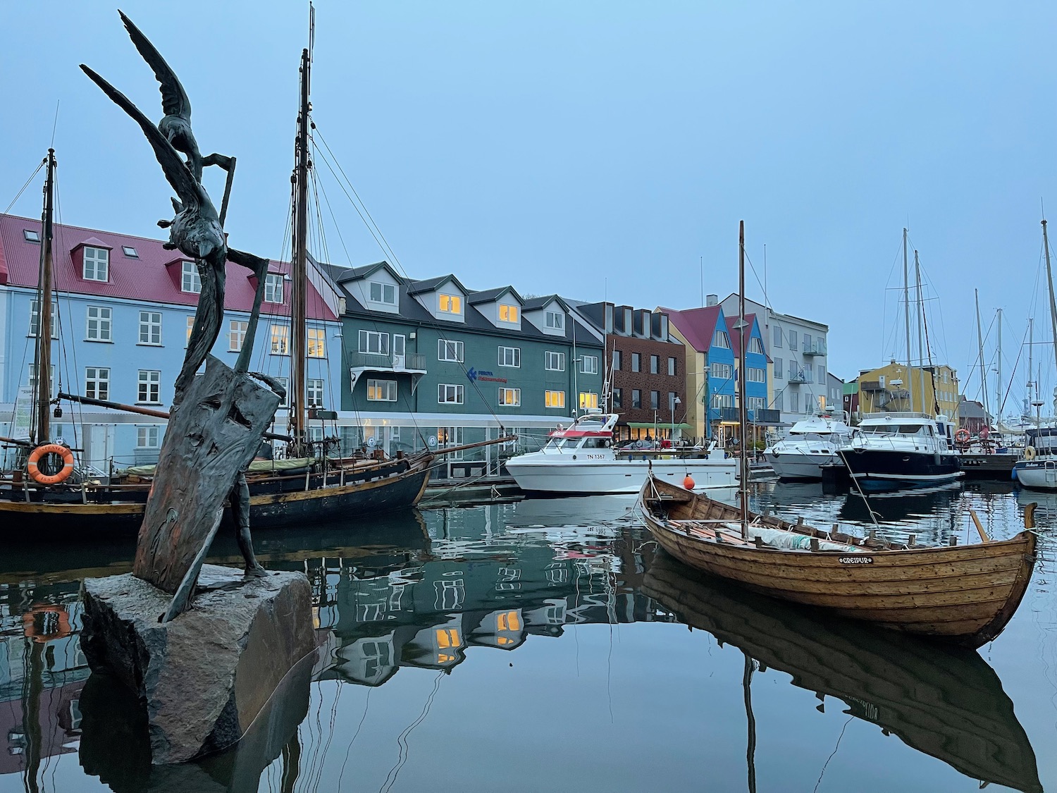 boats in a harbor with boats and buildings