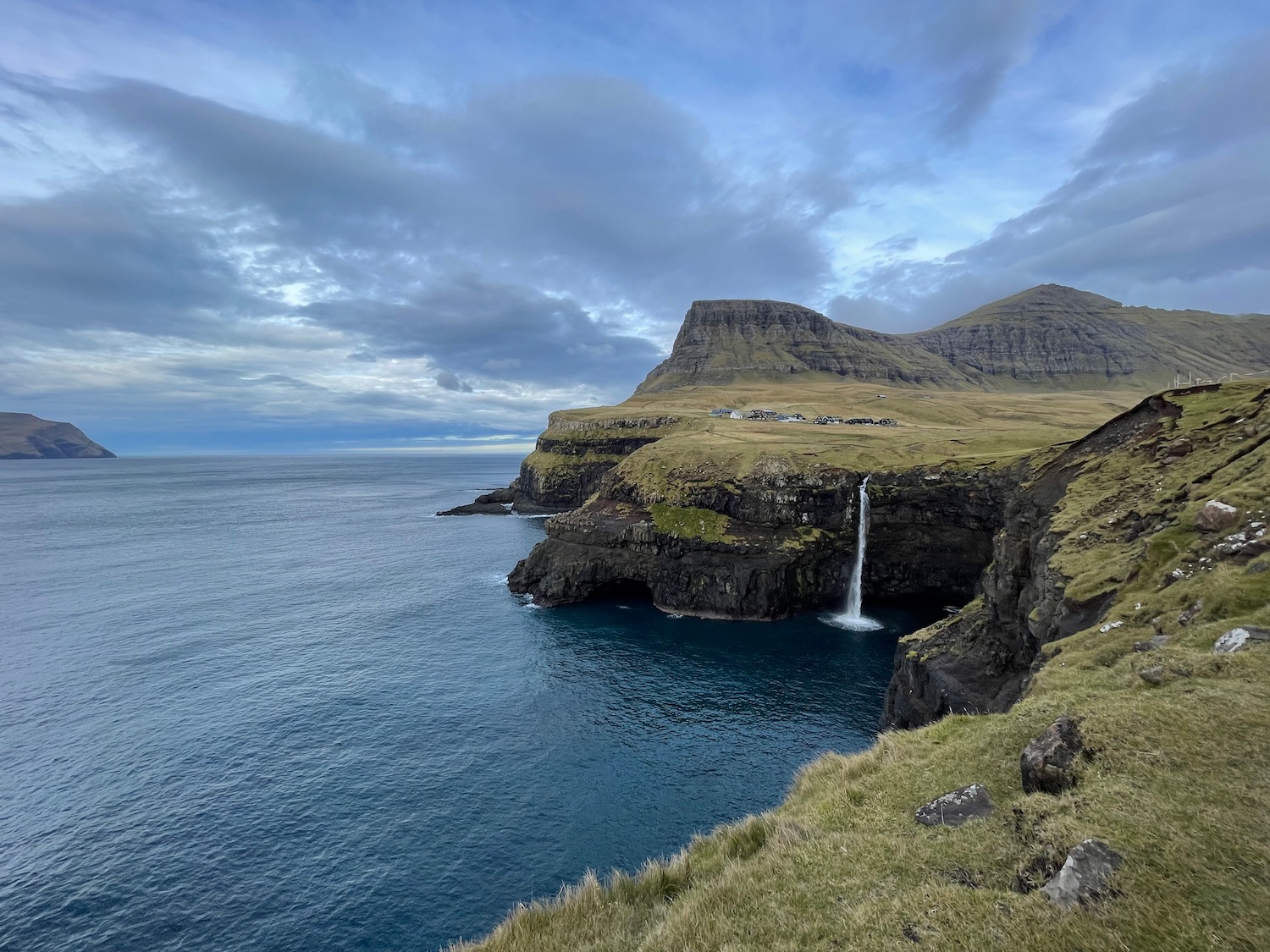 a waterfall over a body of water