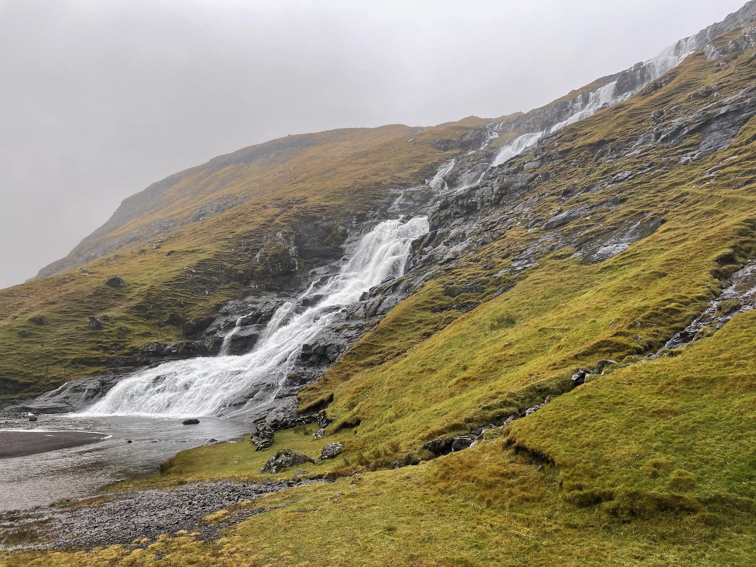 a waterfall on a rocky hill