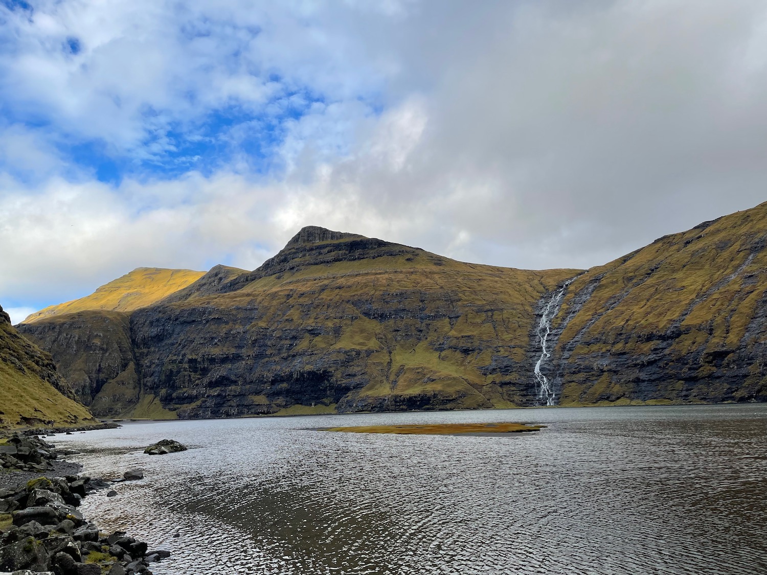 a waterfall over a body of water