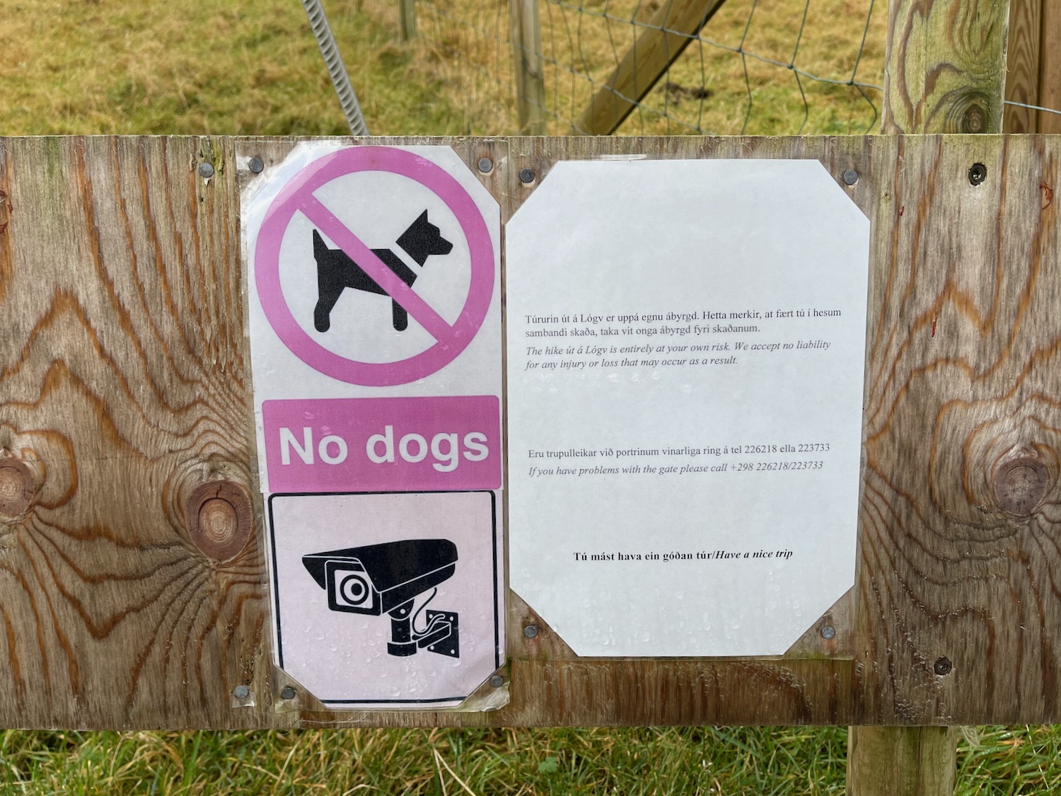 a sign on a wooden fence