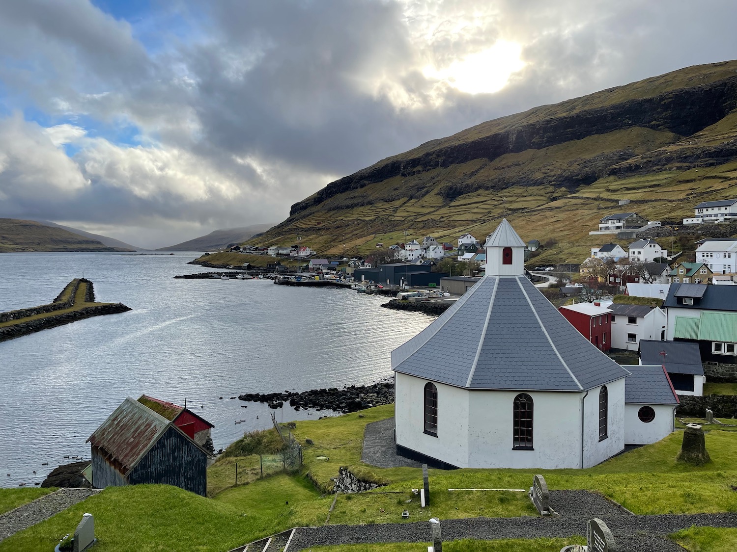 a white building next to a body of water