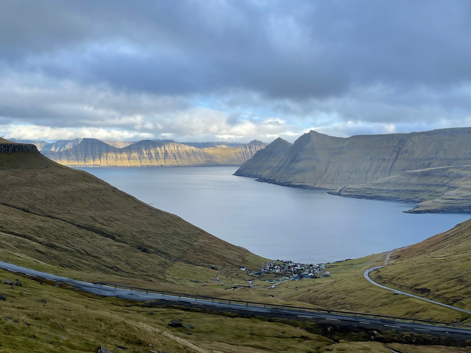 a road next to a body of water