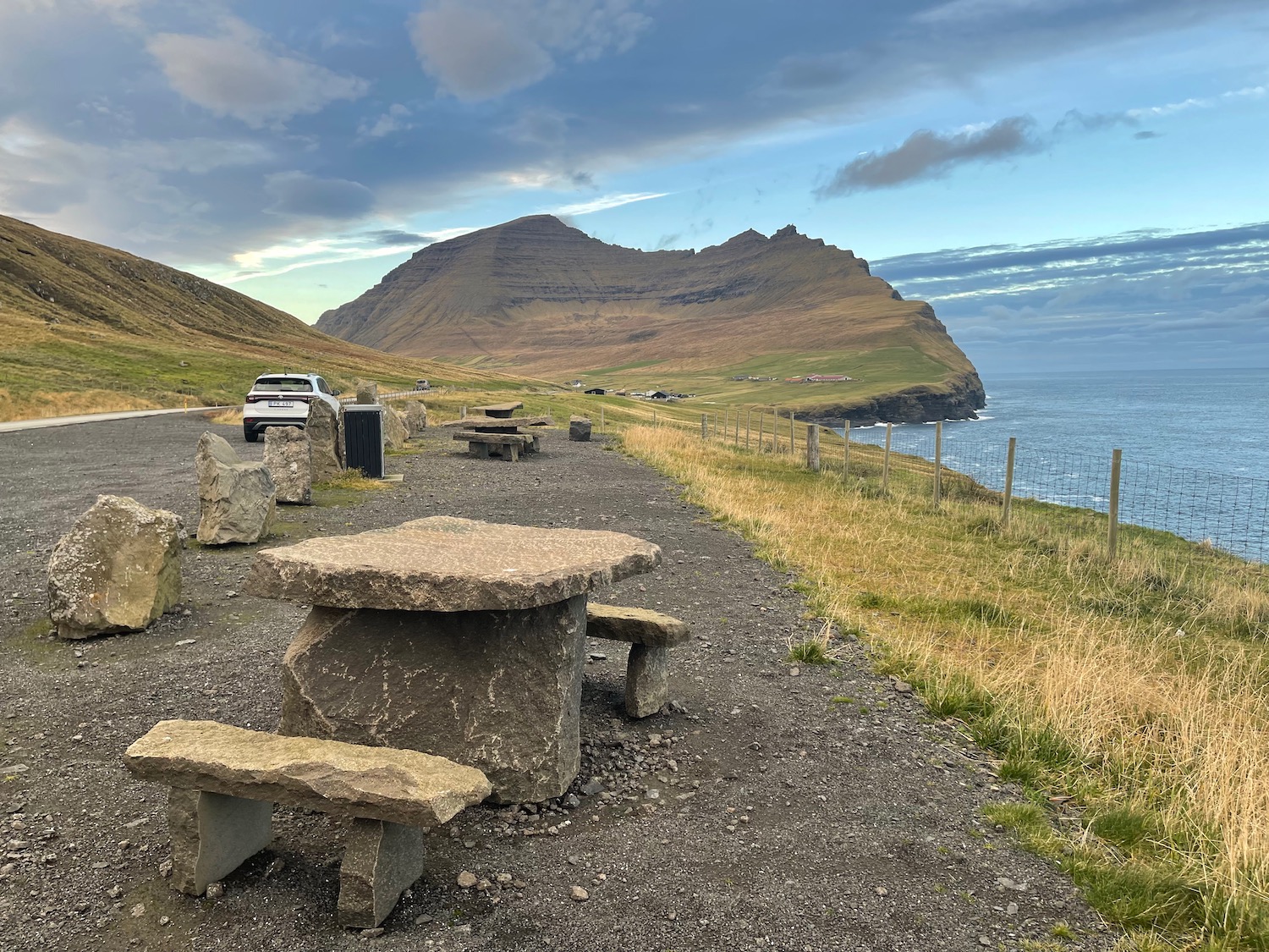 picnic tables next to a body of water