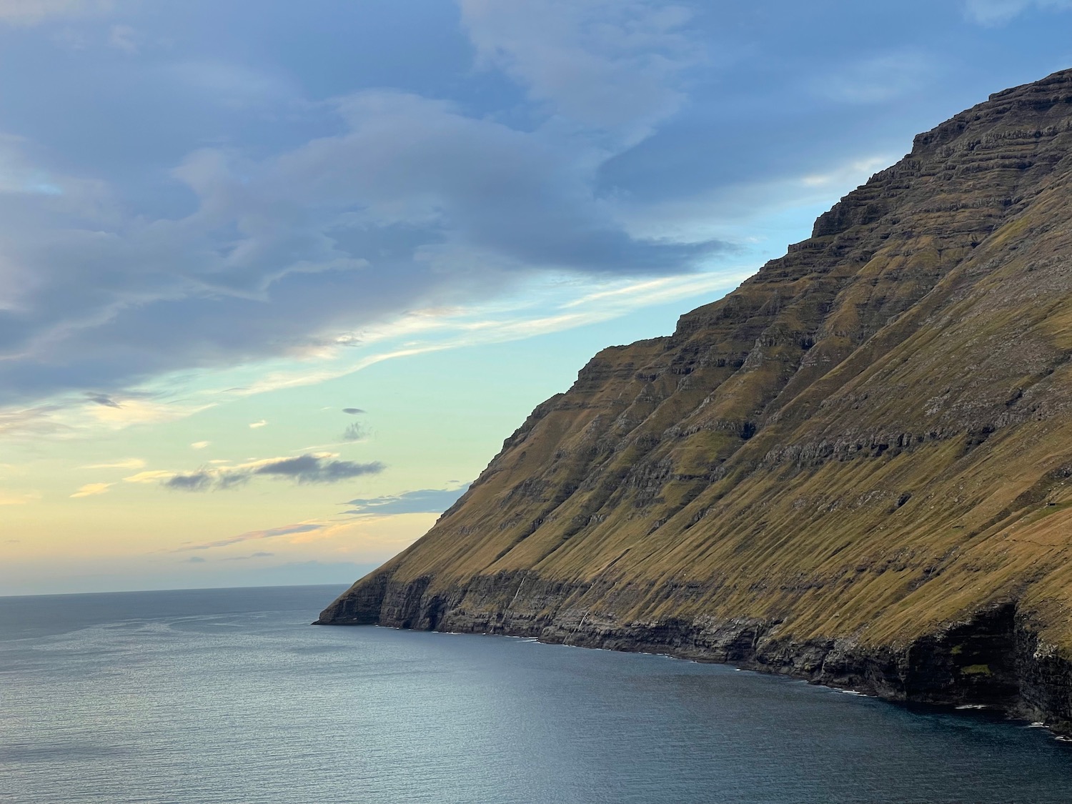 a cliff next to the water