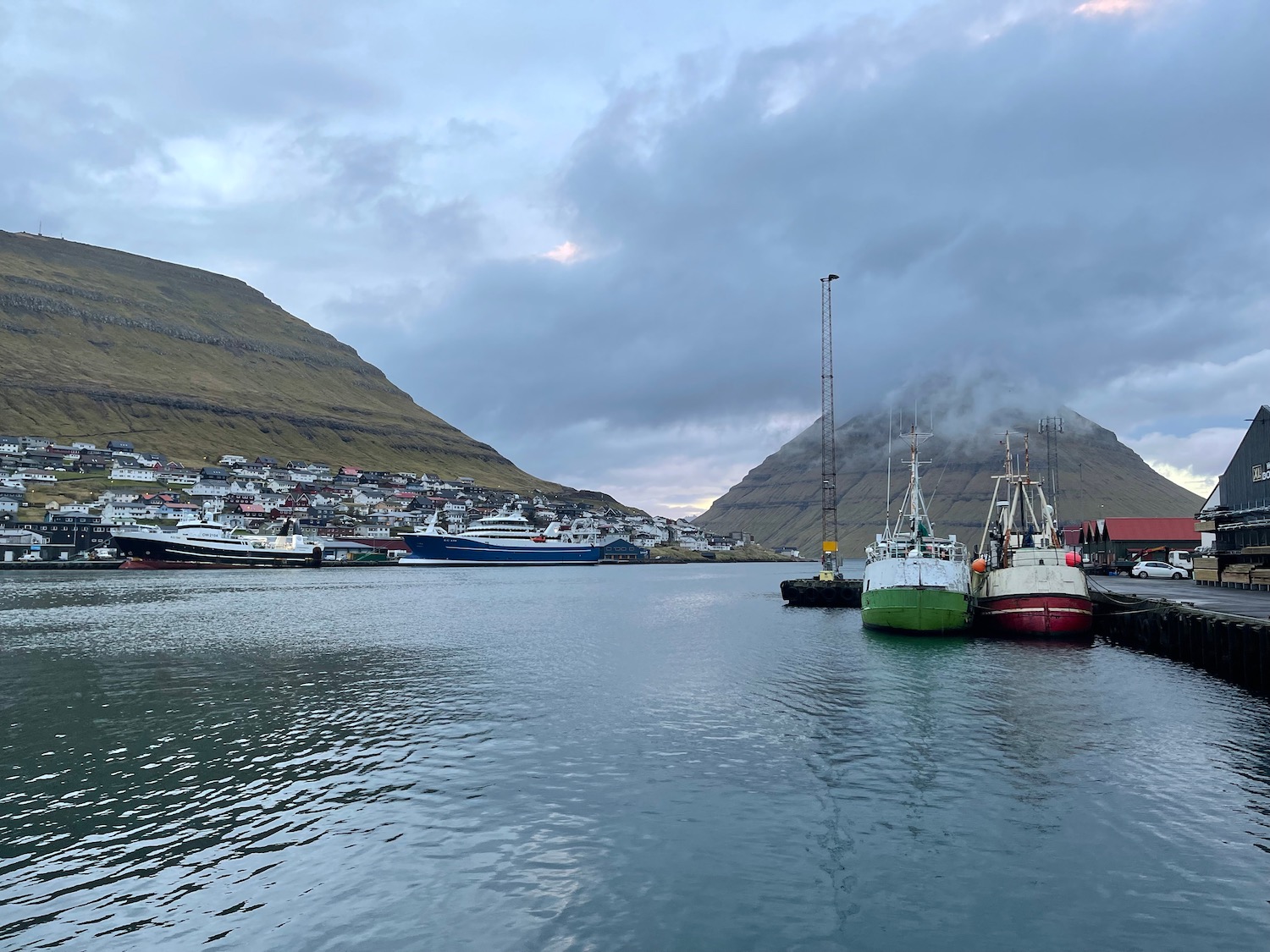 boats in a harbor with a city in the background