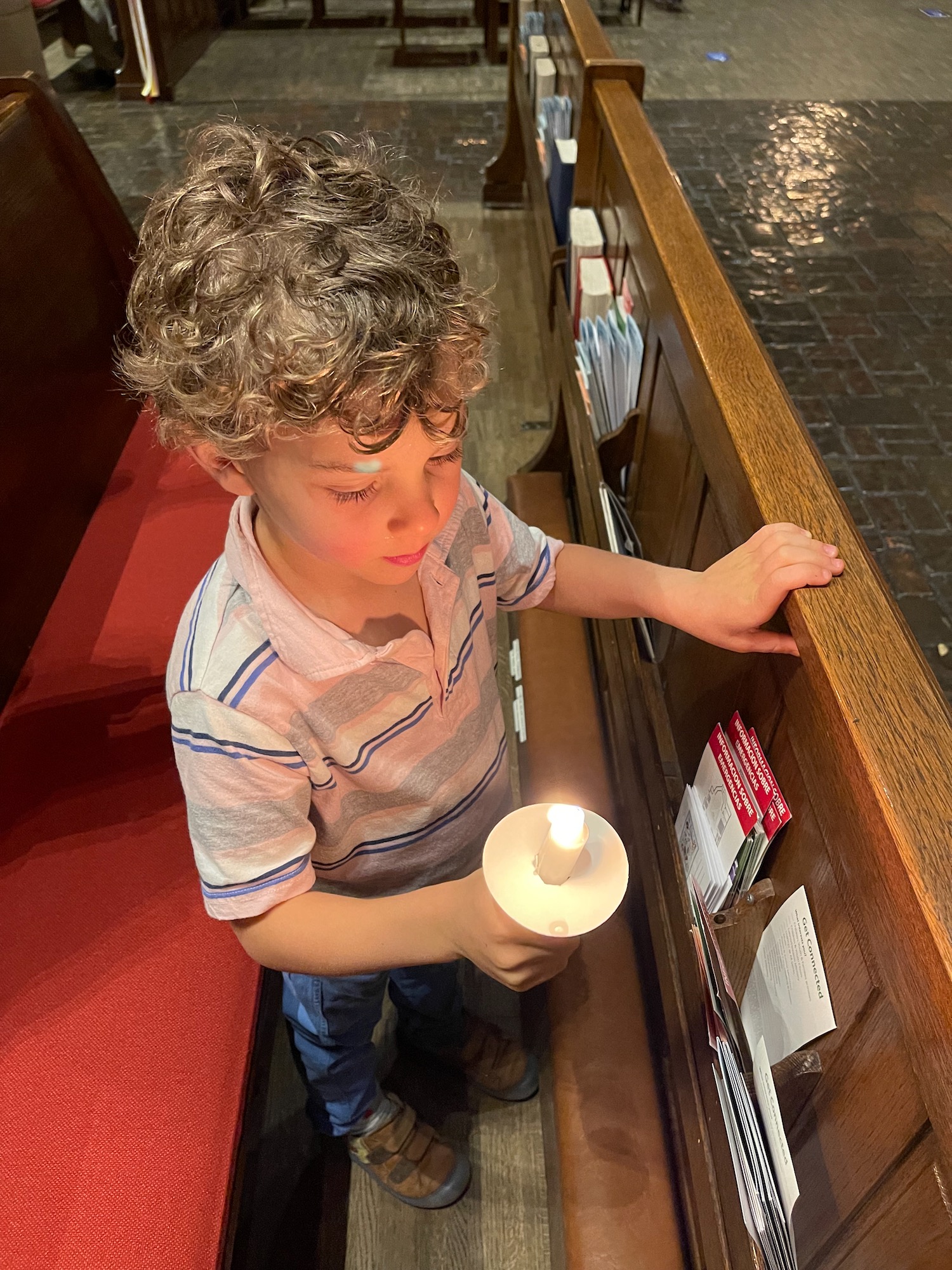 a boy holding a candle