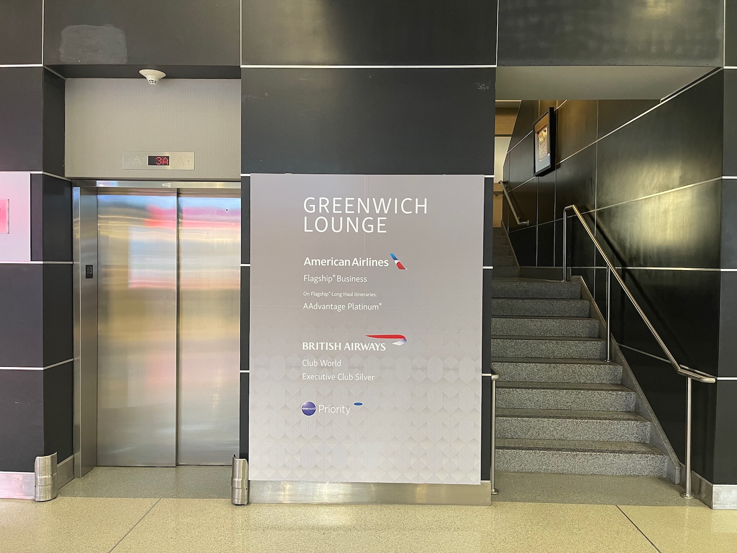 an elevator with a sign and stairs