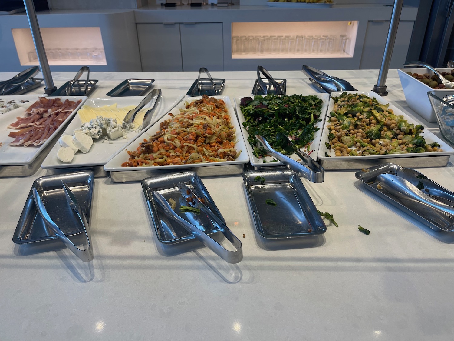 a buffet table with trays of food