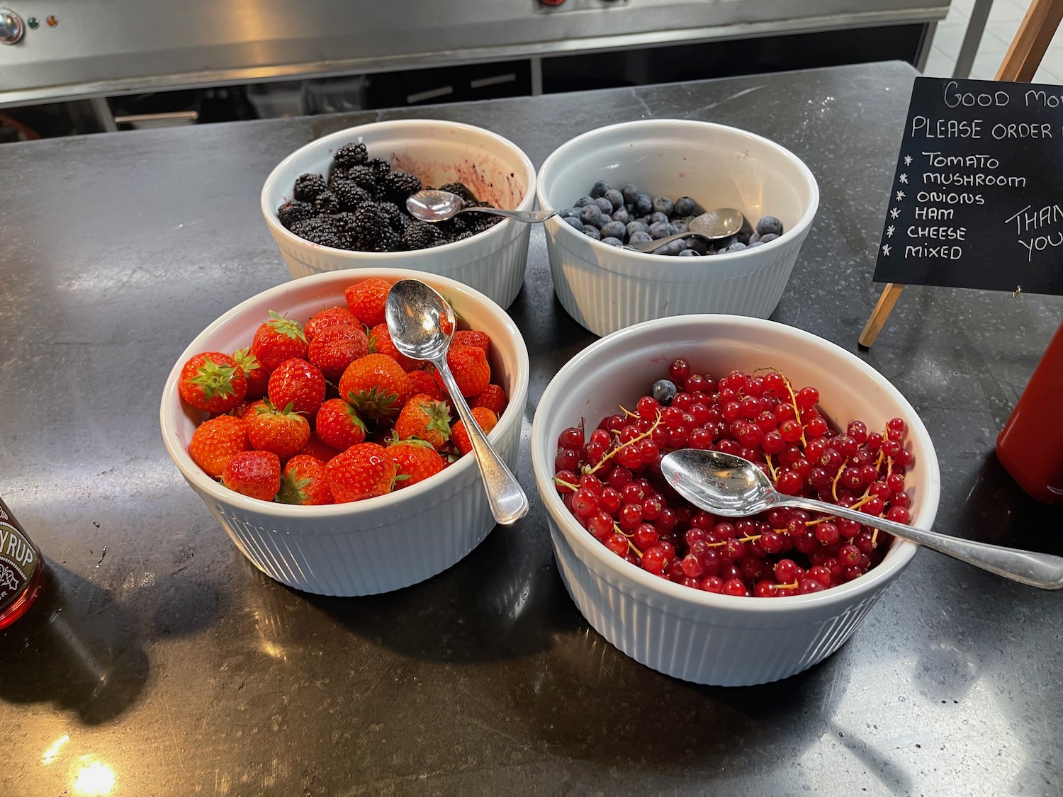 a group of bowls of berries