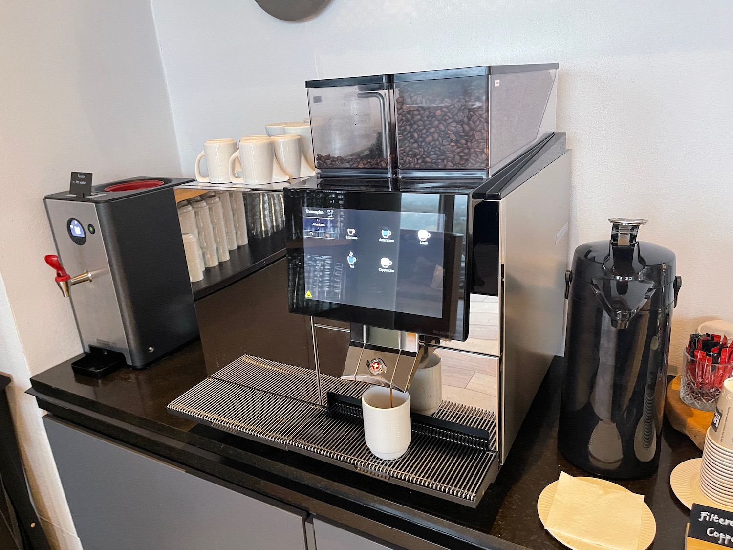 a machine with a screen and coffee beans on it