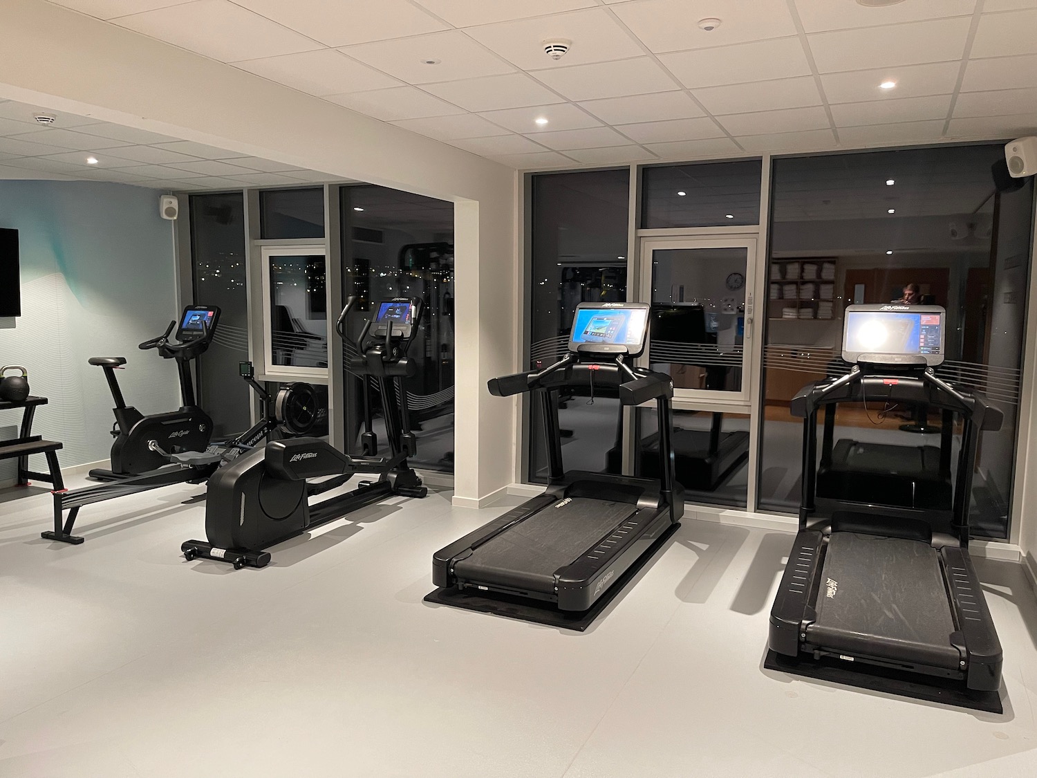 a room with treadmills and a laptop