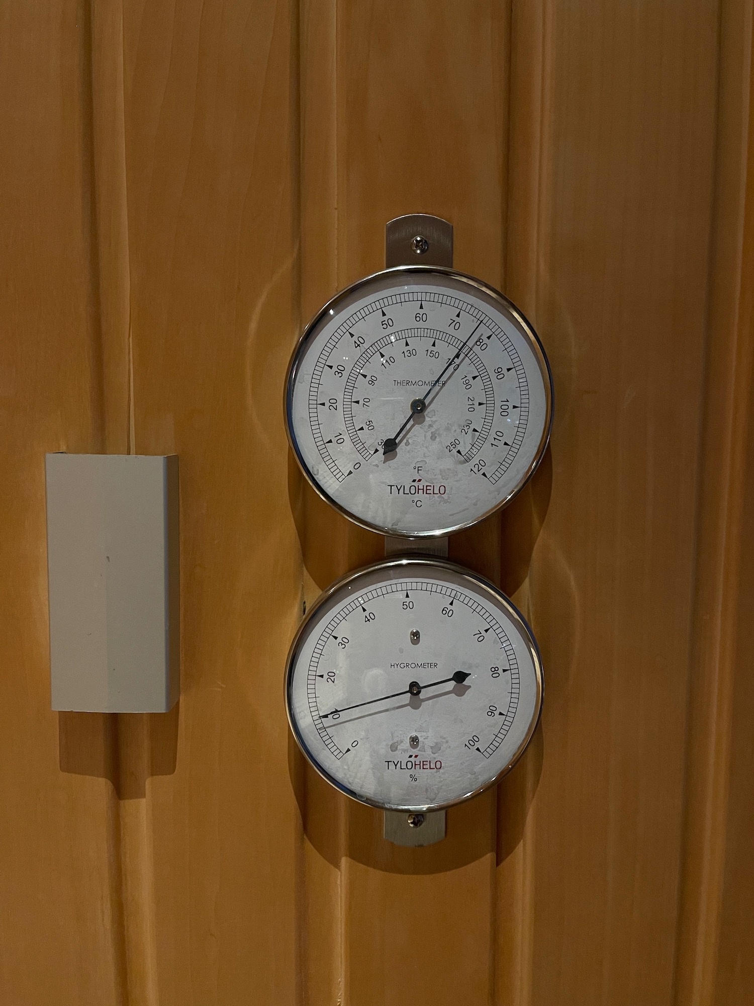 a two gauges on a wooden wall