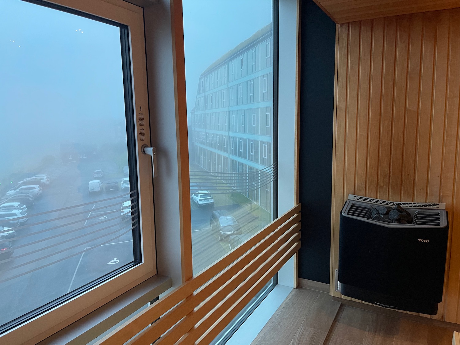 a window with a view of a street and cars outside