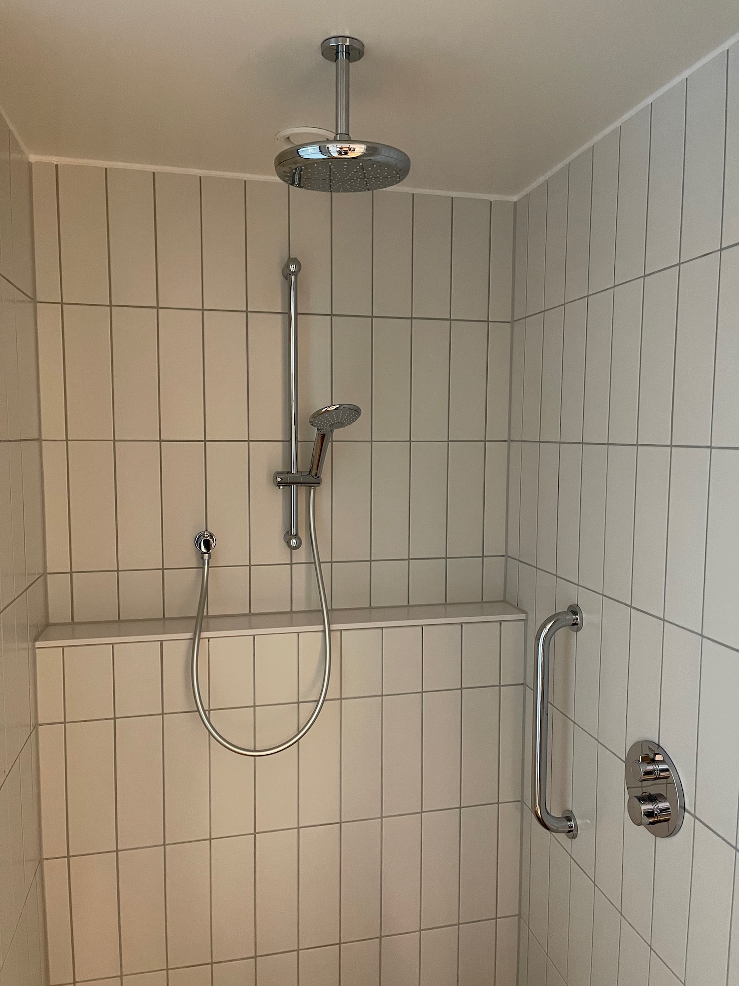 a shower with a shower head and a shower head