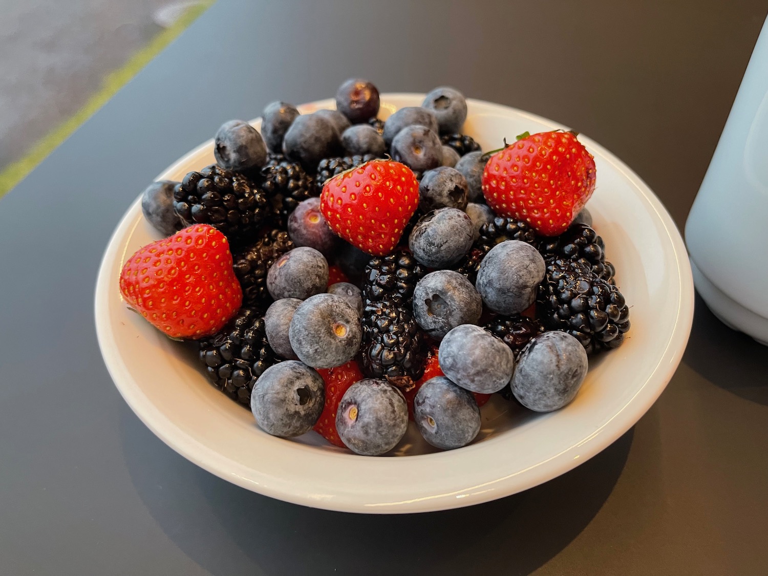 a bowl of berries on a table