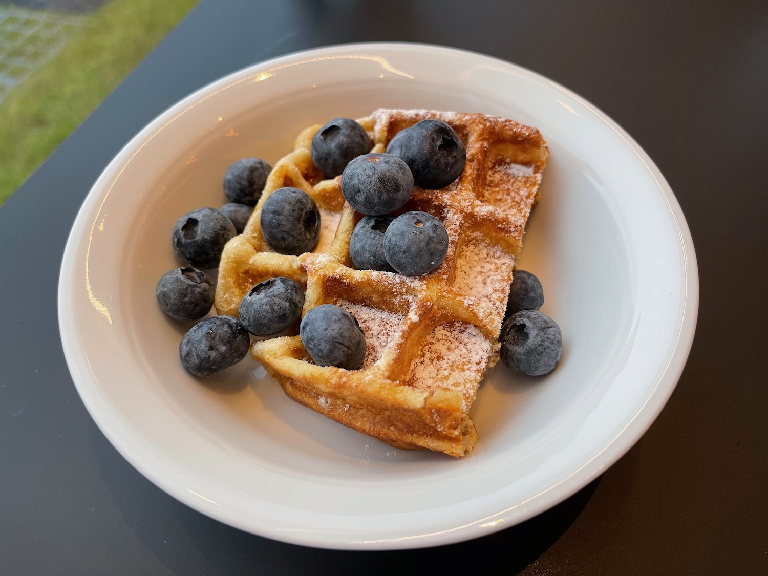 a waffle with blueberries on top of it