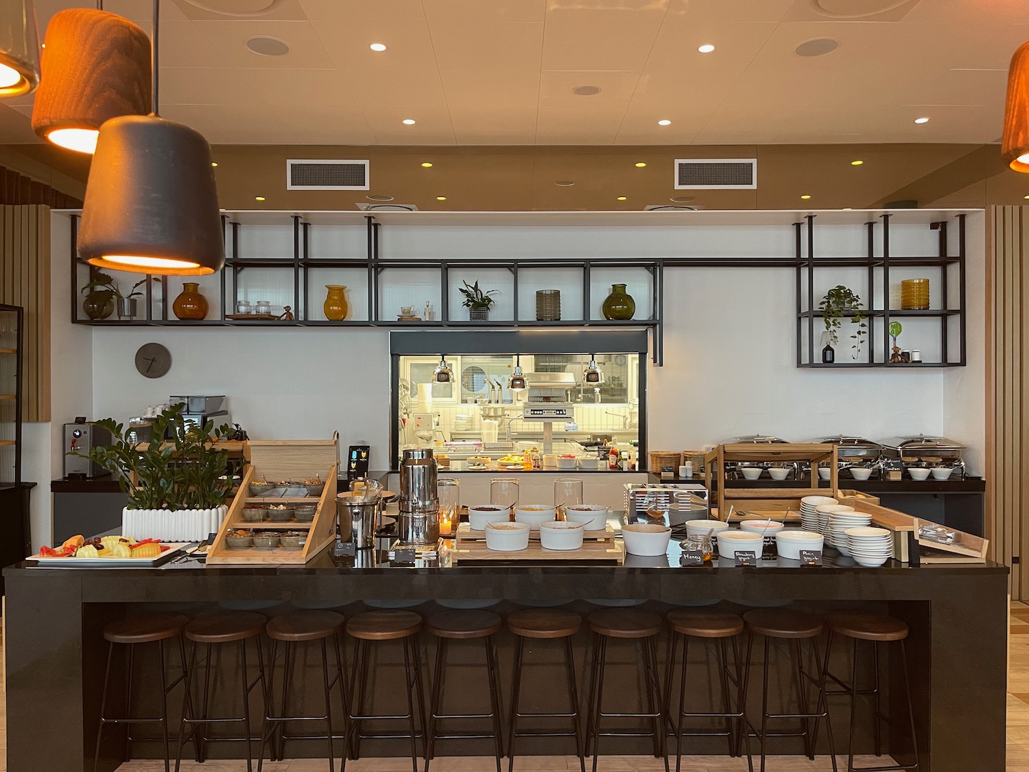 a restaurant with a large counter and chairs