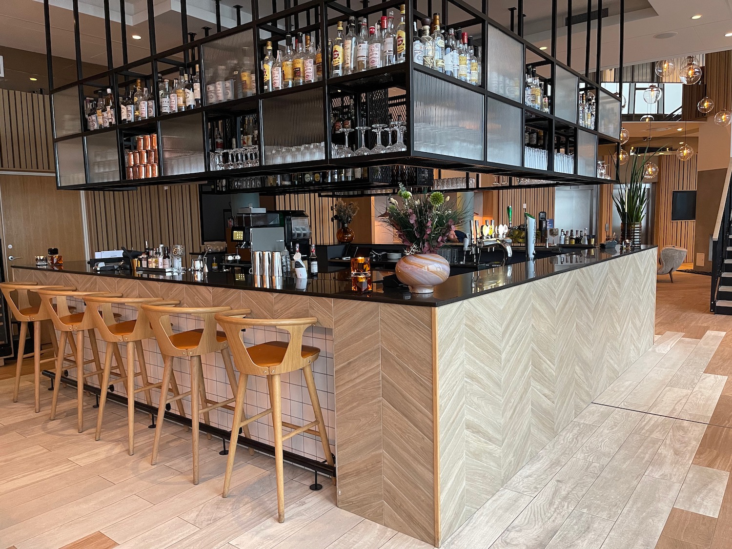 a bar with shelves and stools