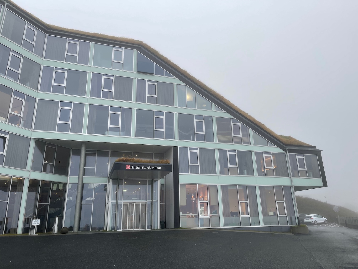 a building with a roof and a parking lot