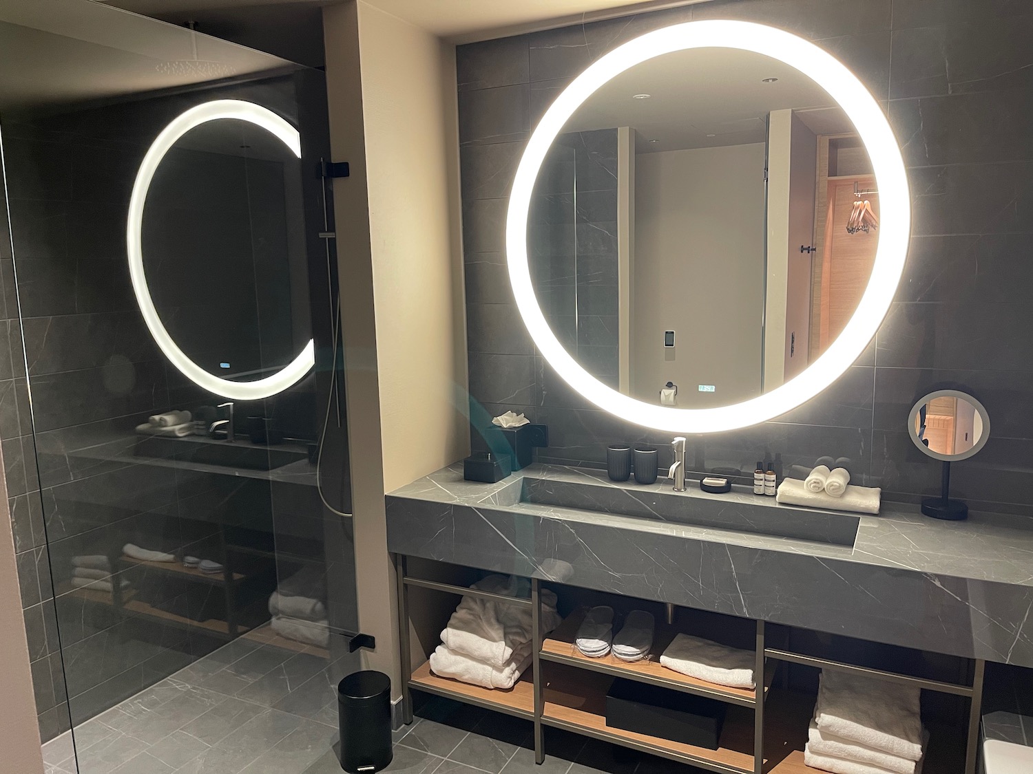 a bathroom with a large round mirror