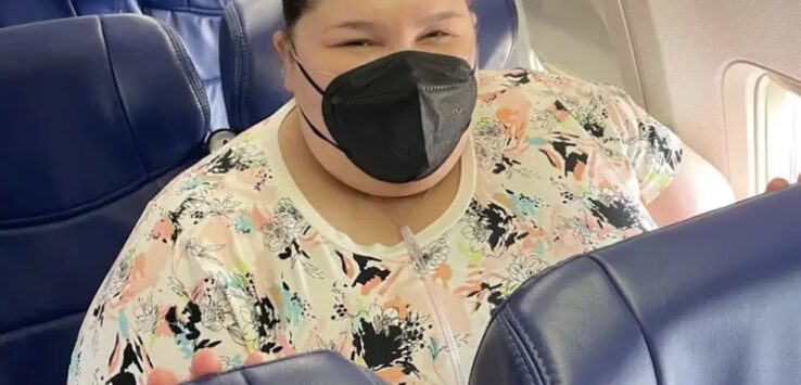 a woman wearing a face mask on an airplane