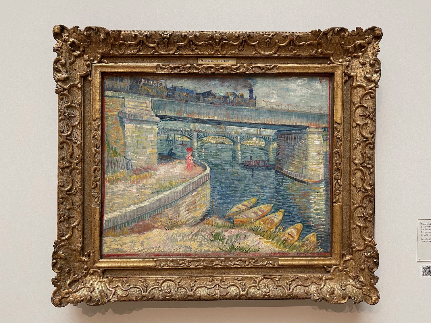 a painting of a bridge and boats in a gold frame