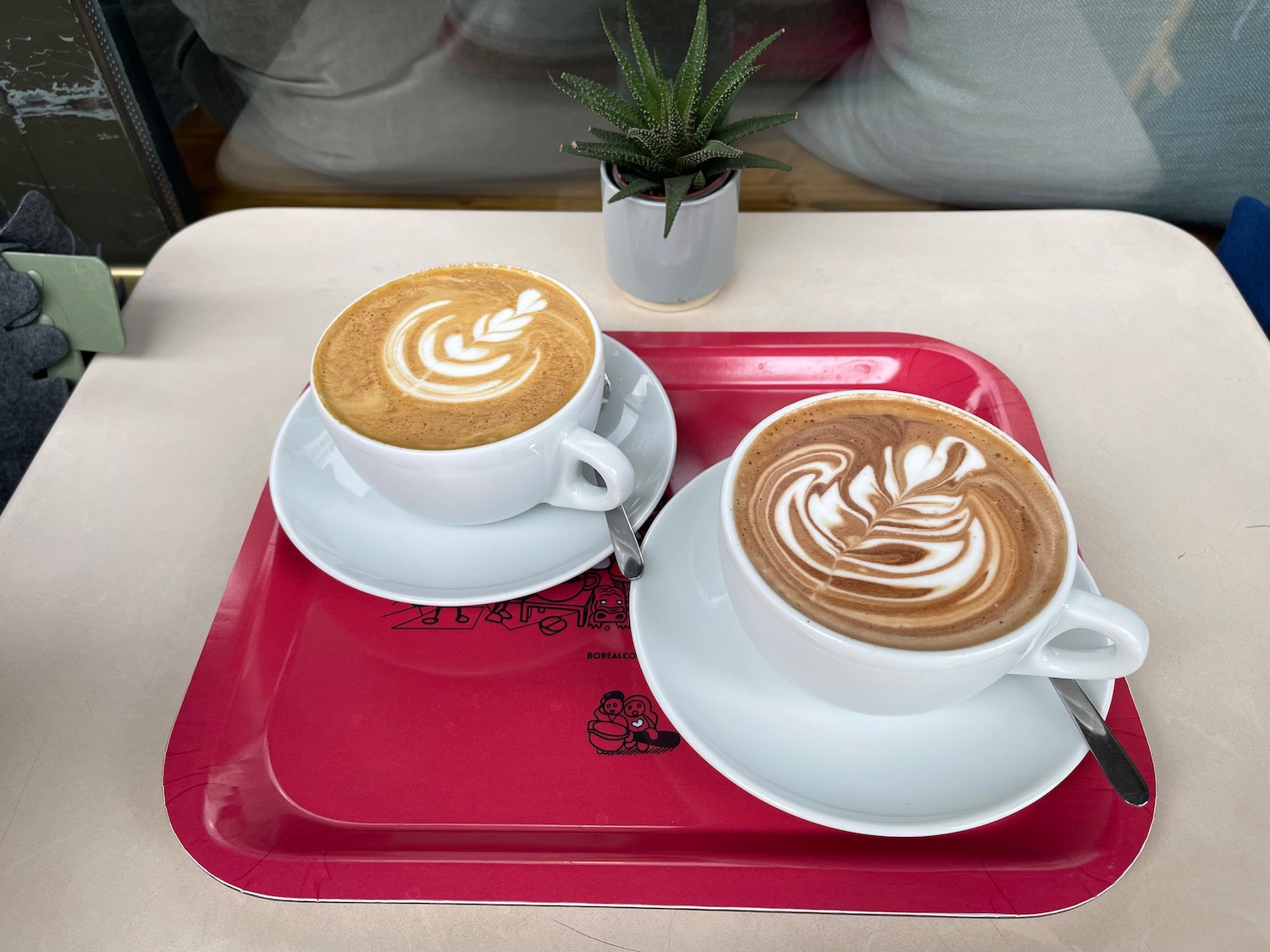 two cups of coffee on a tray