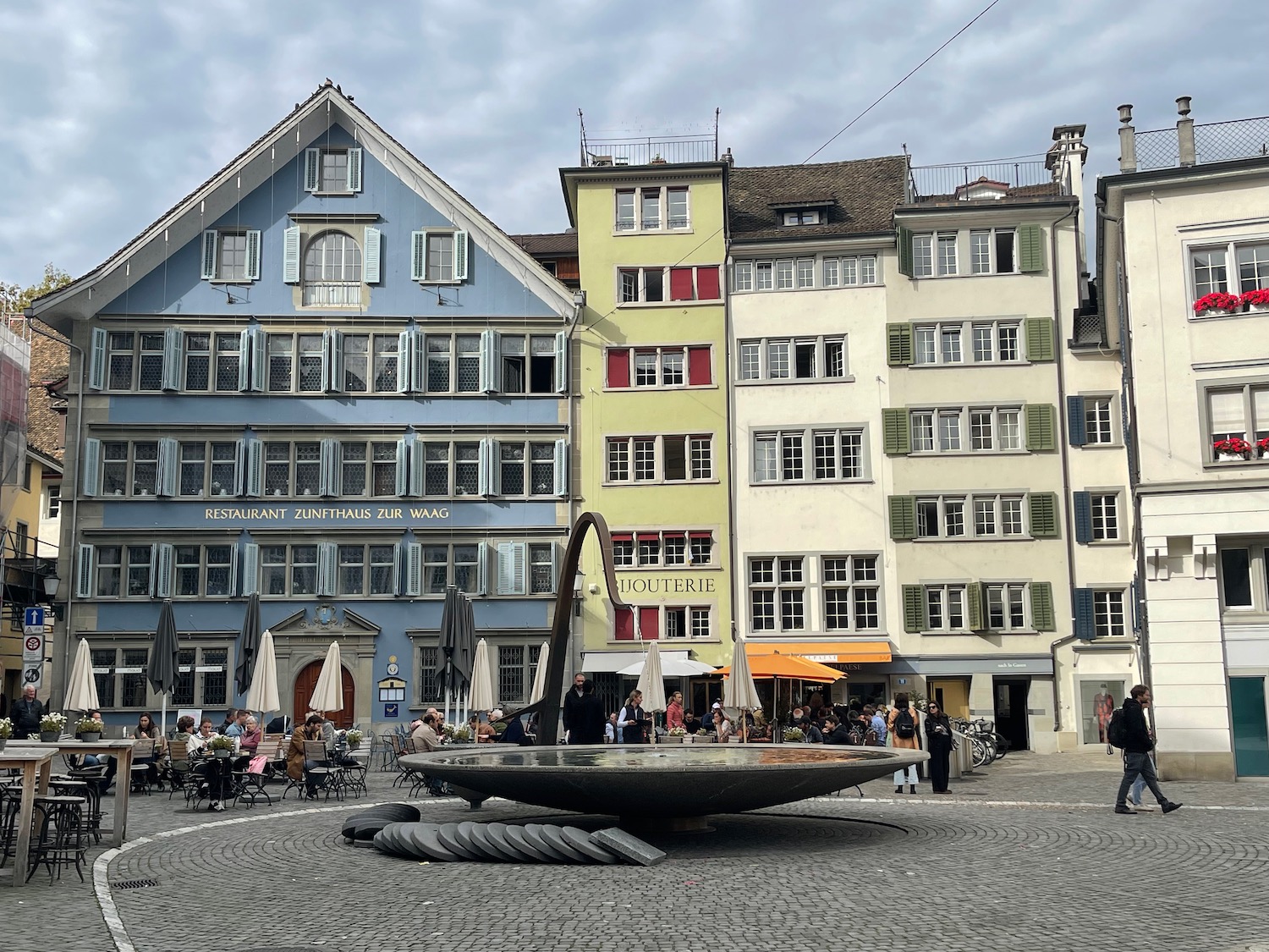 a group of people in front of buildings