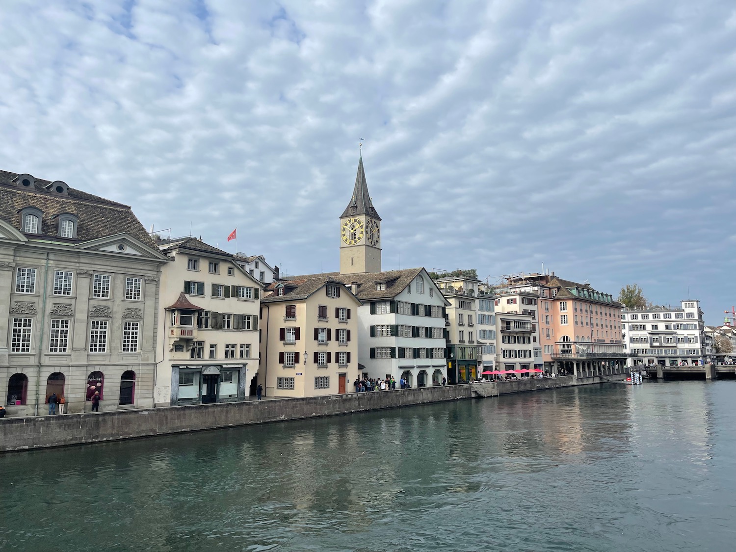 a river with buildings and a clock tower