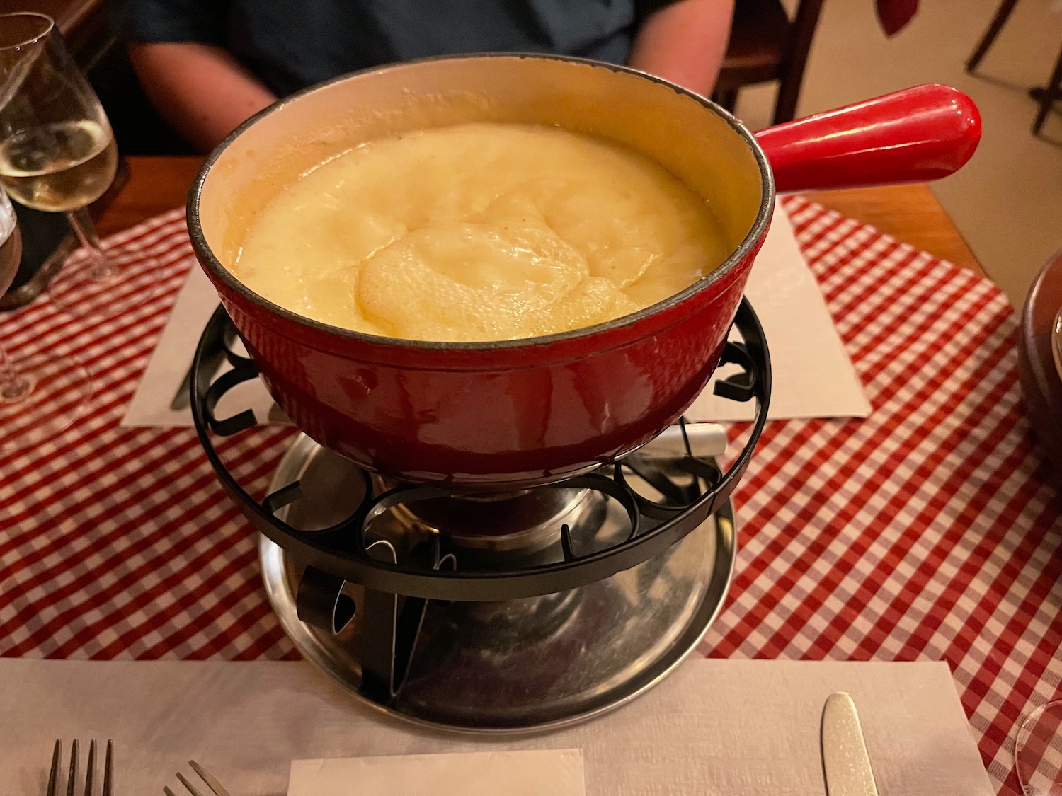 a pot of cheese fondue on a table