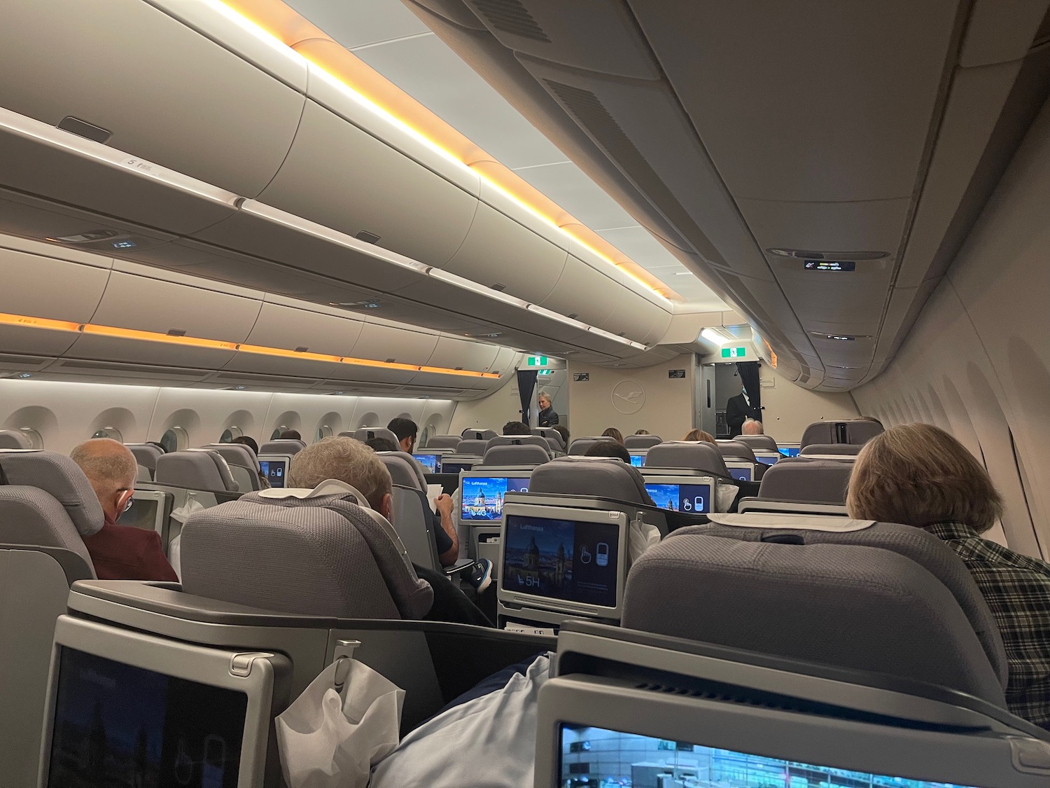 people sitting in an airplane with a group of people