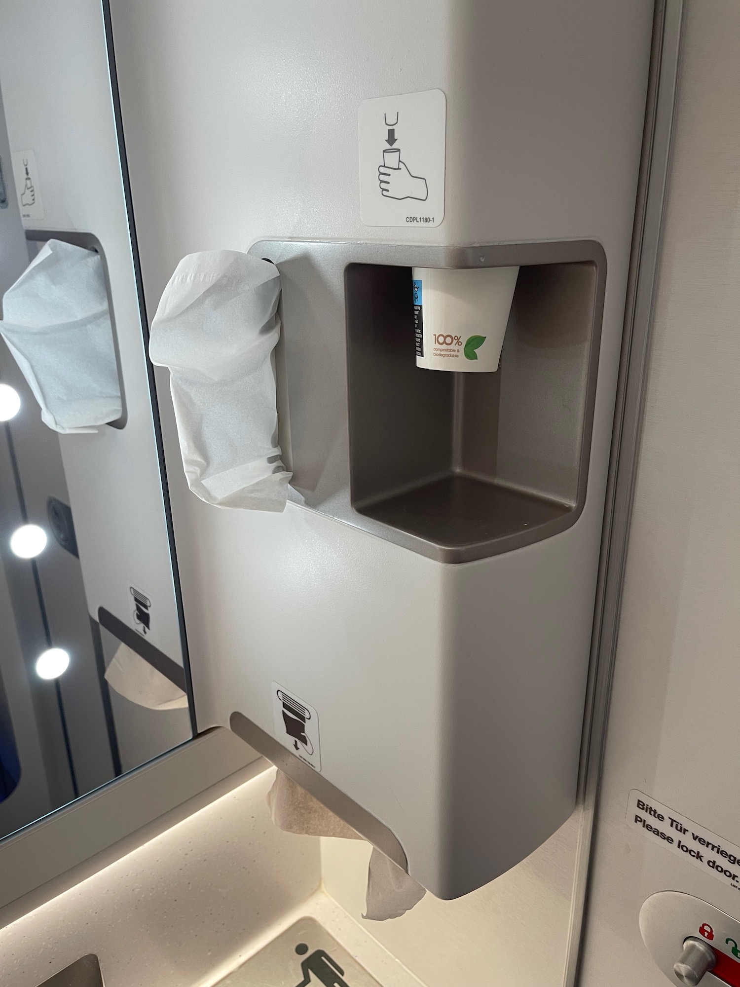 a paper towel dispenser and a cup