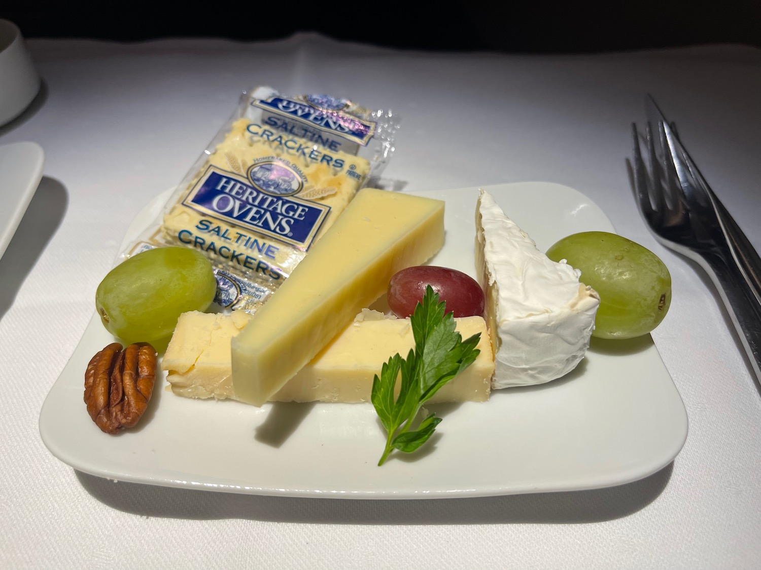 a plate of cheese and grapes