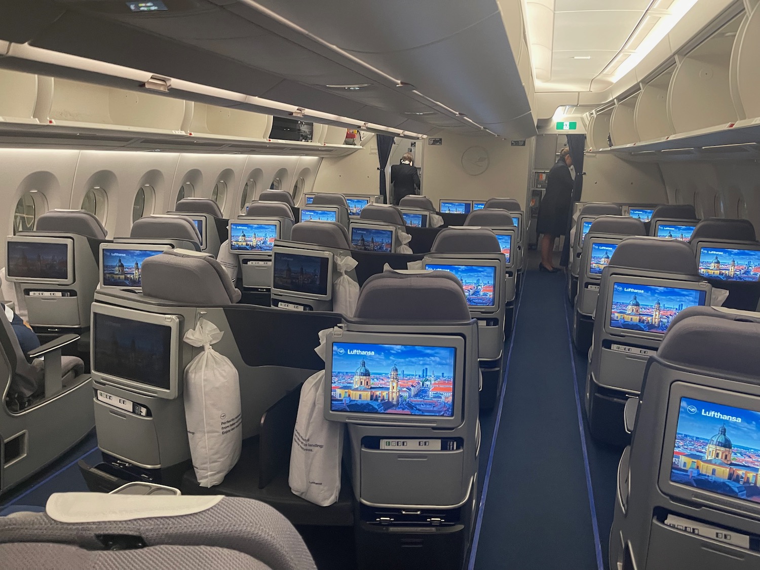 a row of seats with monitors on the side