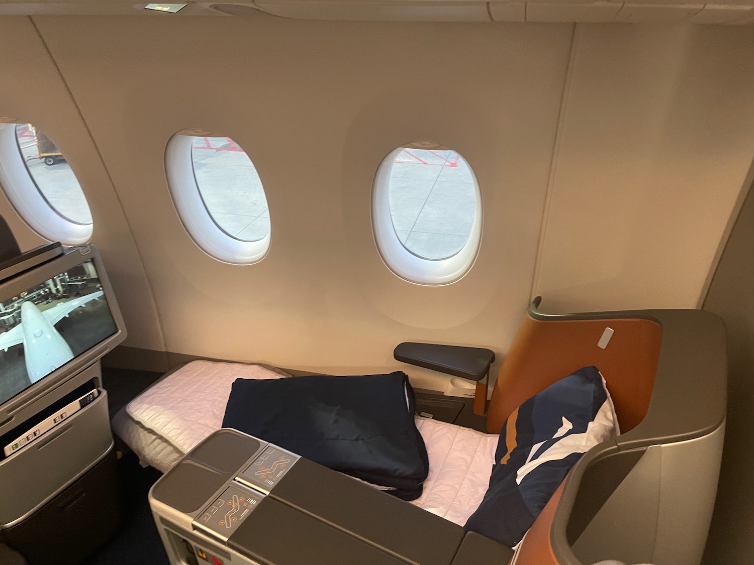 a bed and a television in an airplane